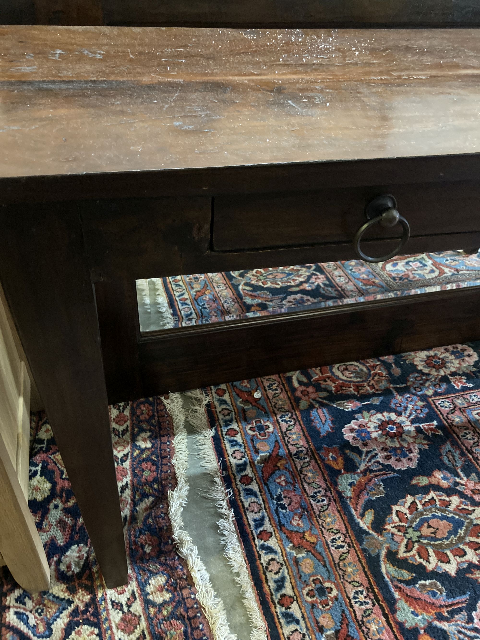 An Indian hardwood table, width 140cm, depth 40cm, height 76cm and a matching wall mirror